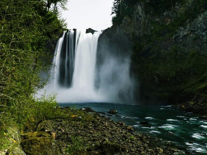 Snoqualmie Falls dramatic waterfall with teal pool and forested cliffs
